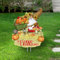 Personalized Welcome garden stake with a gnome pushing a pumpkin-filled wheelbarrow, mushrooms and sample Evans Family wording.