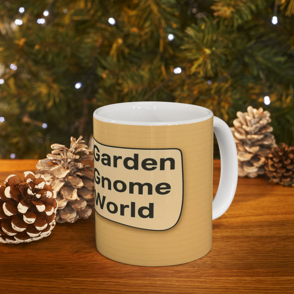 Beige mug with 'Garden Gnome World' text in front of a Christmas tree and pinecones.