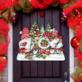 Door decoration showing three red-hatted Christmas gnomes with gifts, candy canes, cardinals and snowy trees.