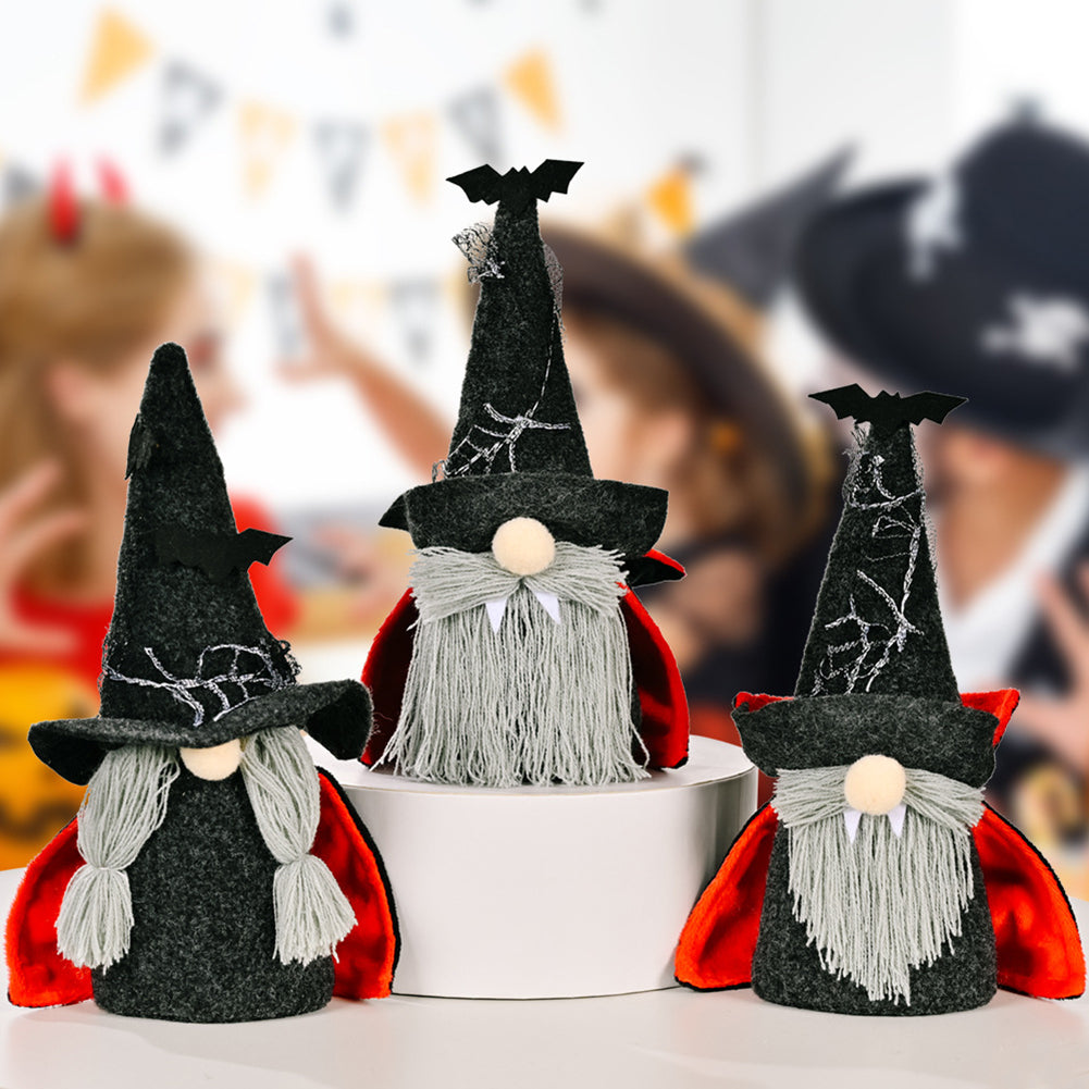 Three Halloween plush gnomes with black spiderweb hats, gray beards or braids, red-lined capes and bat details.