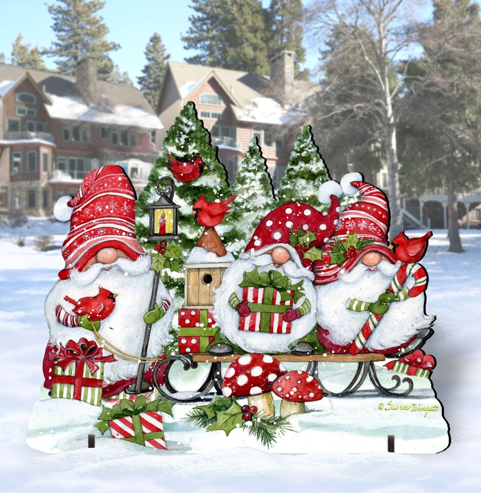 Outdoor Christmas decoration with three red-hatted gnomes, presents, cardinals and trees in a snowy setting.