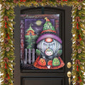 Happy Halloween door decoration with a BOO-hatted gnome, pumpkins and spiderwebs, mounted on a black door.