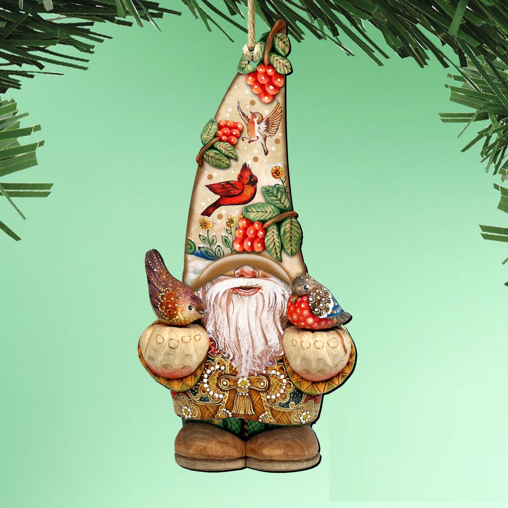 Hanging gnome ornament with a tall berry-and-bird-decorated hat, white beard and two birds perched on its mittens.