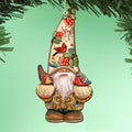 Hanging gnome ornament with a tall berry-and-bird-decorated hat, white beard and two birds perched on its mittens.