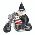 Black-hatted gnome wearing sunglasses and a leather-style jacket, riding a motorcycle with stars and stripes.