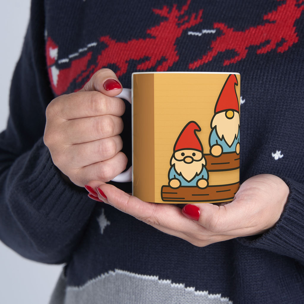 Person holding a mug with gnome design, wearing a sweater