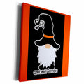 Canvas wall art with an orange border showing a black witch-hatted gnome, hanging spider and Gnome Witch wording.