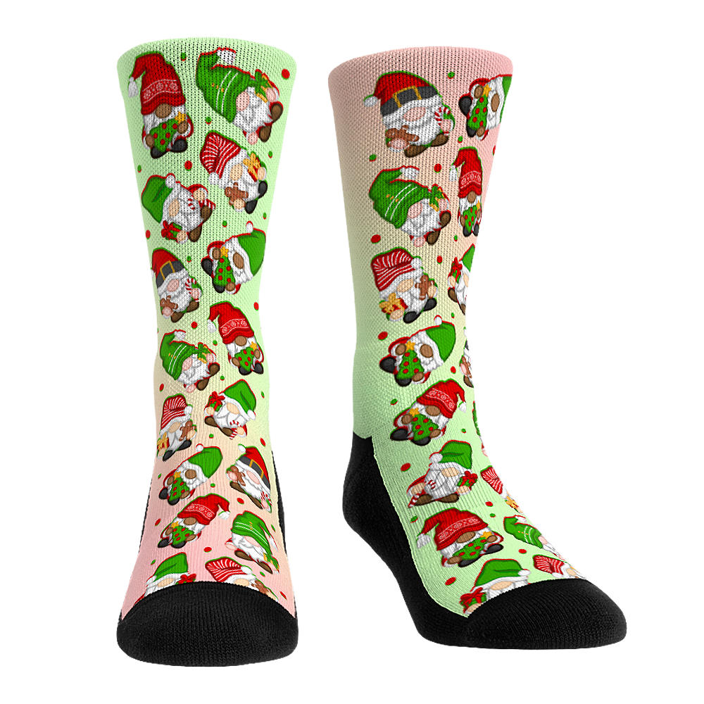 Pair of pastel green and pink socks patterned with Christmas gnomes, with black heels and toes.