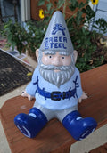 Garden gnome figurine that is customizable with 'Green Steel' This hat on a wooden surface outdoors