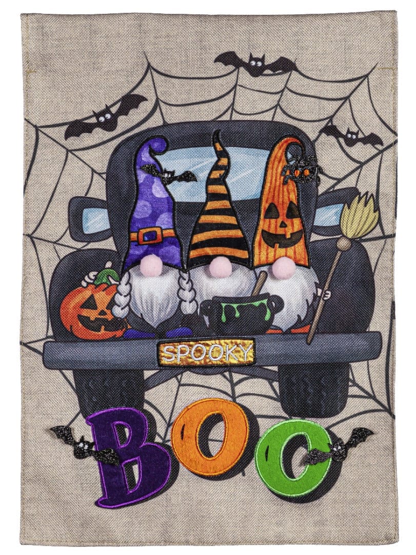 Garden flag with three Halloween gnomes in a truck marked SPOOKY, surrounded by spiderwebs, bats and colorful BOO letters.