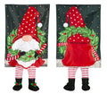 Front and back views of a red-hatted gnome garden flag holding a wreath, with dangling striped legs and black boots.