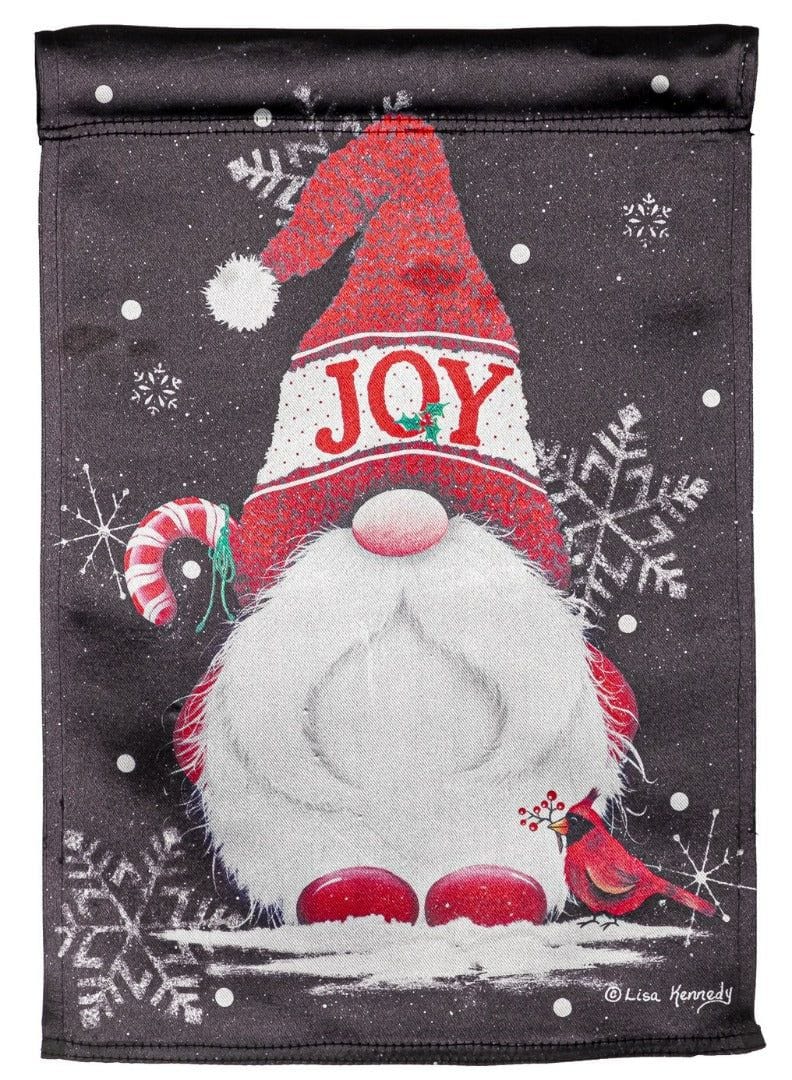 Christmas garden flag with a white-bearded gnome wearing a red JOY hat, a candy cane, cardinal and snowflakes.