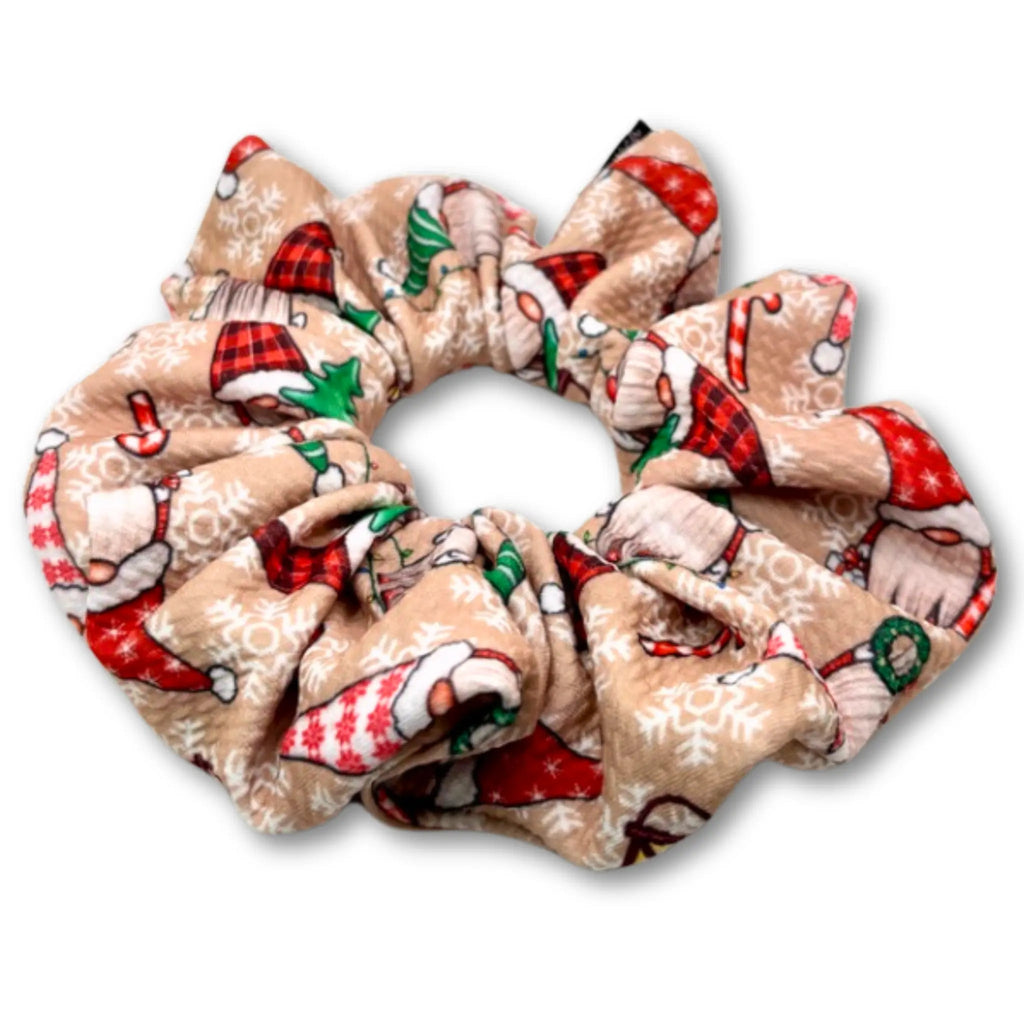Beige gathered scrunchie patterned with Christmas gnomes, red hats, green trees, candy canes and snowflakes.