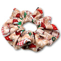 Beige gathered scrunchie patterned with Christmas gnomes, red hats, green trees, candy canes and snowflakes.