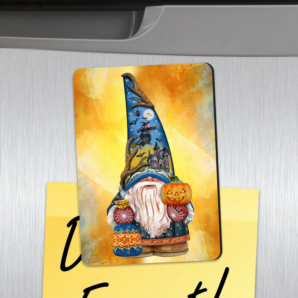 Refrigerator magnet depicting a blue-hatted Halloween gnome with a pumpkin and moonlit haunted-house artwork.