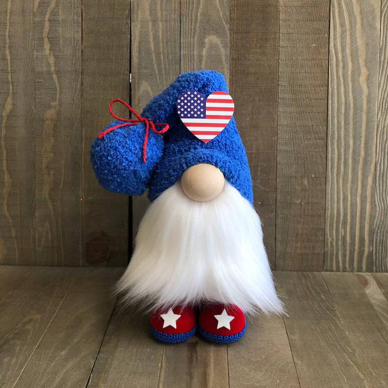 Gnome with blue hat and red shoes against a wooden background