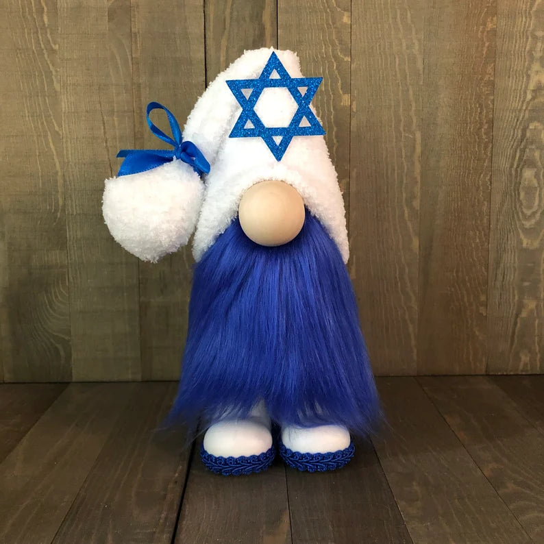 Gnome with blue hat and beard, white beard, and blue shoes against a wooden background