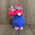 Gnome with pink hat and blue beard on a wooden floor, with 'Happy Birthday' text.