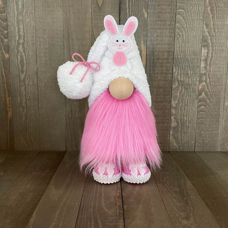 Gnome dressed as a bunny with a pink skirt and white shoes on a wooden background