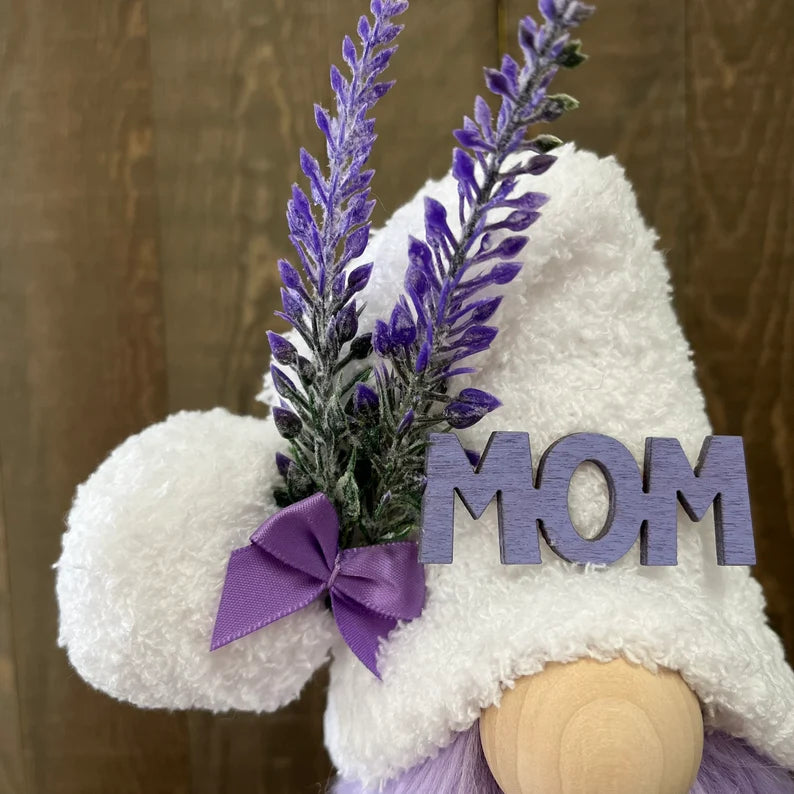 Gnome with lavender and 'MOM' sign against a wooden background