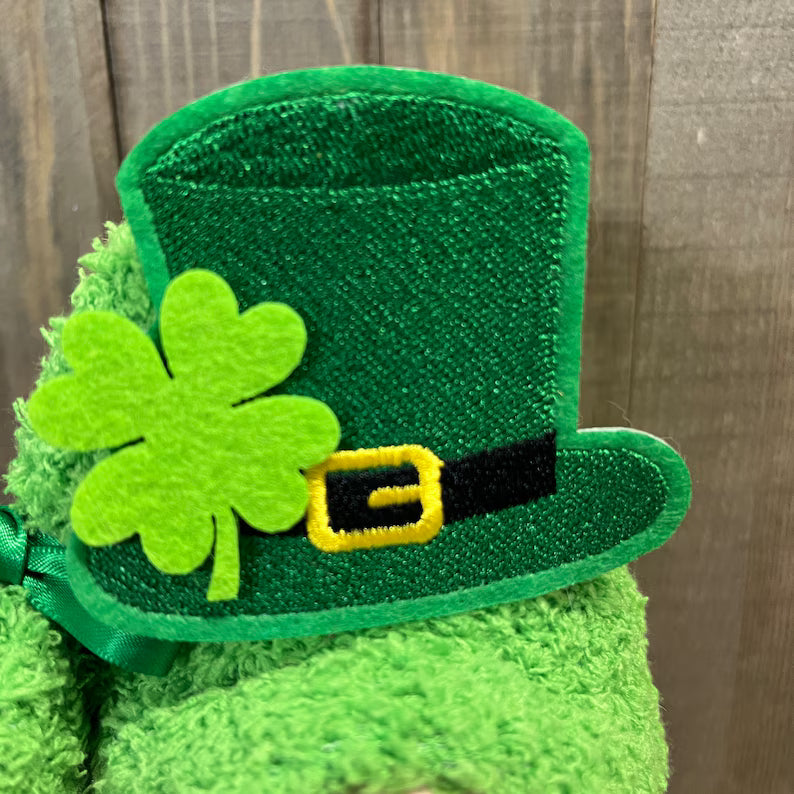 St. Patrick's day handcrafted gnome with a top hat and shamrock on a wooden background