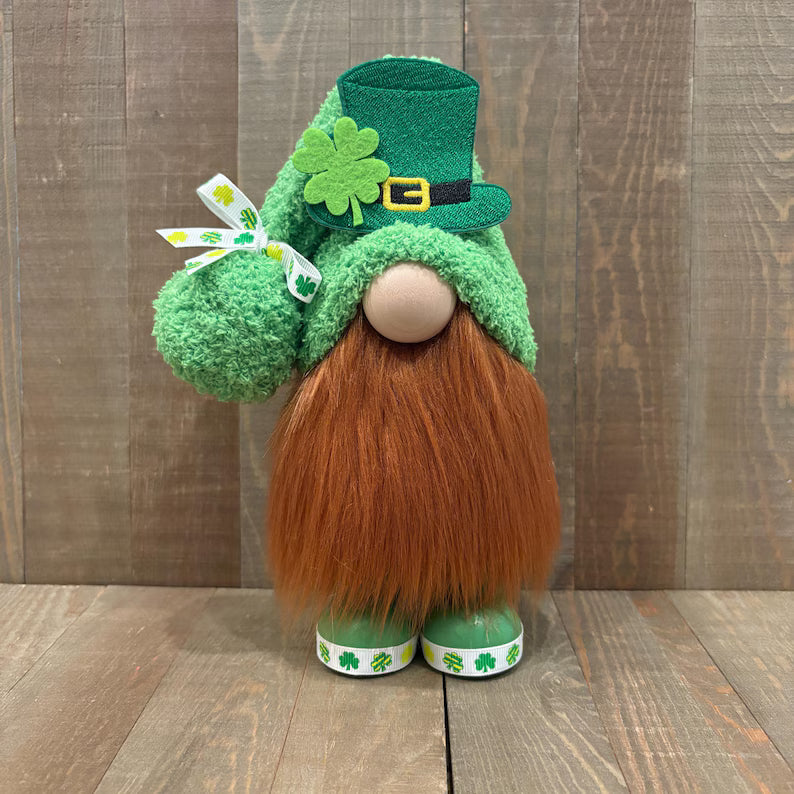 St. Patrick's Day-themed handcrafted gnome with green hat and brown beard on a wooden background
