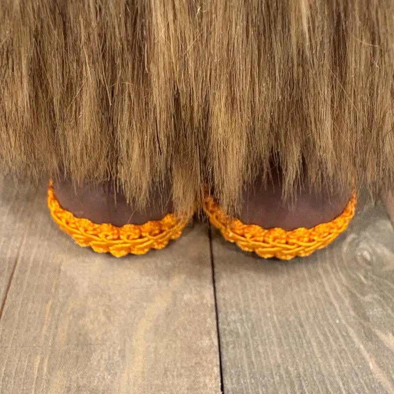 Close up of yellow shoes on a handcrafted gnome.