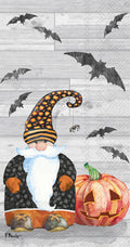 Halloween guest towel design with a black-and-orange gnome, hanging spider, bats and jack-o'-lantern on a woodgrain background.