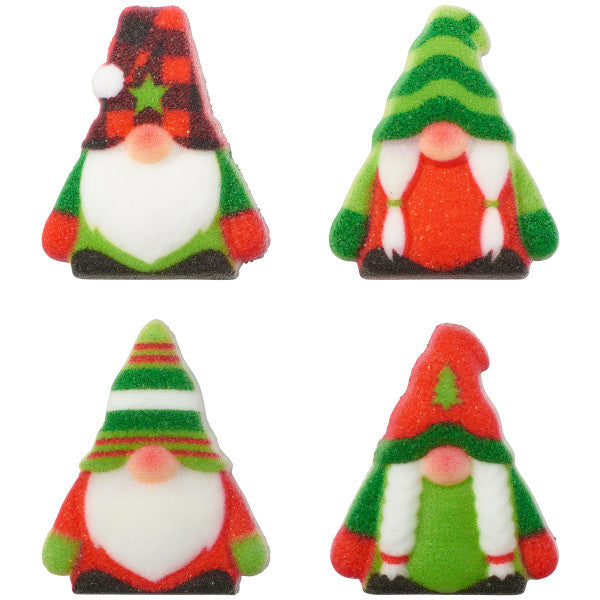 Four red-and-green gnome dessert decorations with white beards and striped or checked Christmas hats.